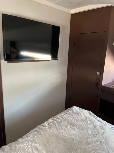 Simorgh Yacht Photos Pics 2019 Prestige 460 yacht interior with TV and cozy bed.