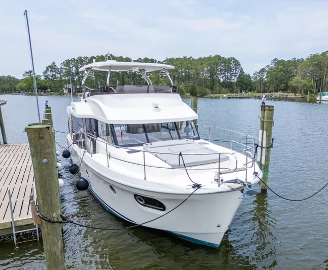Sweetest Southern Comfort Yacht Photos Pics 2022 Beneteau ST48 Swift Trawler 48 docked on a serene lake.