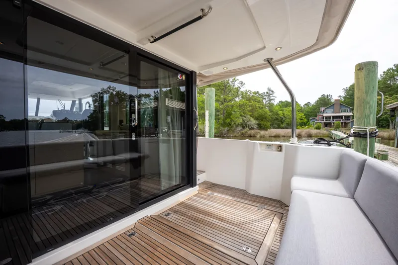 Sweetest Southern Comfort Yacht Photos Pics 2022 Beneteau ST48 Swift Trawler 48 deck with seating and glass doors.