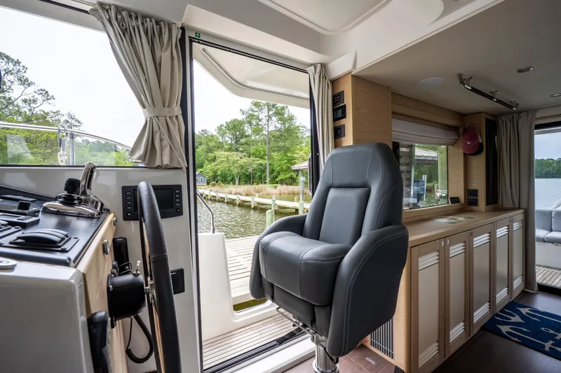 Sweetest Southern Comfort Yacht Photos Pics Interior of 2022 Beneteau ST48 Swift Trawler 48, featuring helm seat and scenic view.