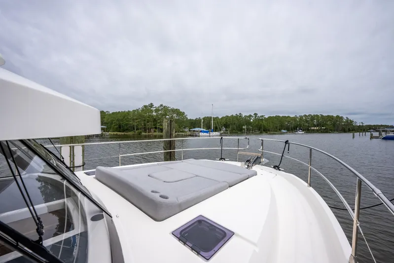 Sweetest Southern Comfort Yacht Photos Pics 2022 Beneteau ST48 Swift Trawler 48 on calm water, featuring spacious deck and scenic view.