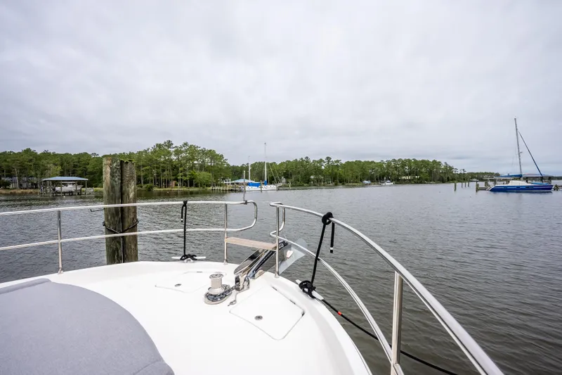 Sweetest Southern Comfort Yacht Photos Pics Bow view of 2022 Beneteau ST48 Swift Trawler 48 on a calm river.
