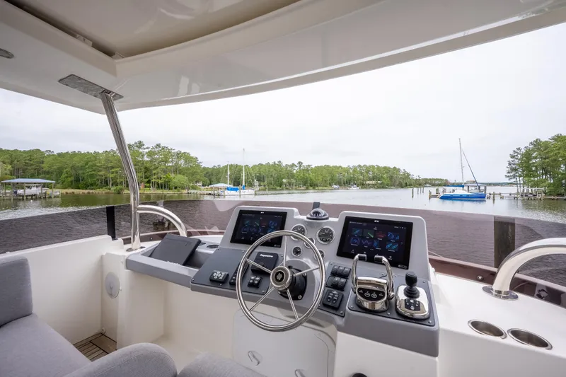 Sweetest Southern Comfort Yacht Photos Pics Helm of 2022 Beneteau ST48 Swift Trawler with modern navigation equipment, overlooking serene waters.