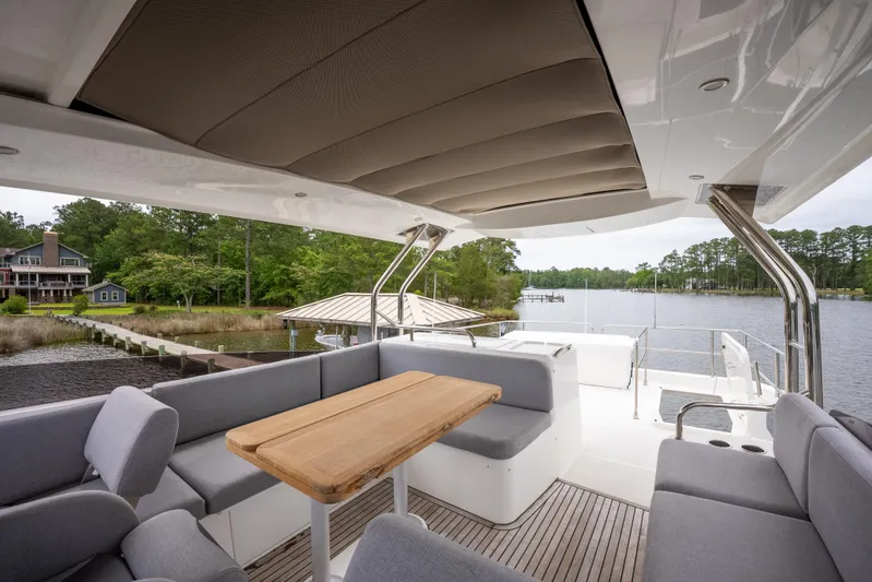 Sweetest Southern Comfort Yacht Photos Pics Luxurious 2022 Beneteau ST48 Swift Trawler 48 with spacious outdoor seating and scenic water view.