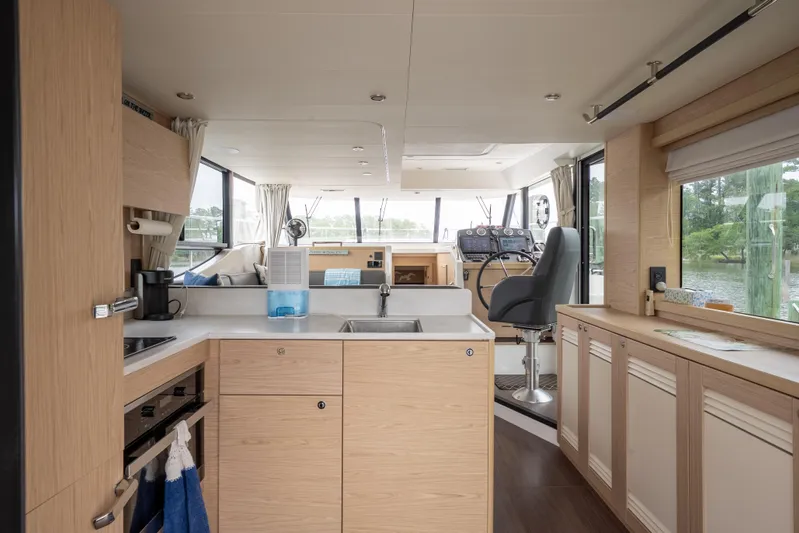 Sweetest Southern Comfort Yacht Photos Pics Interior of 2022 Beneteau ST48 Swift Trawler 48, featuring modern kitchen and helm station.
