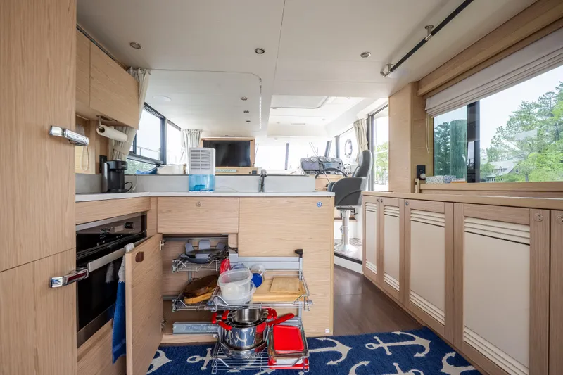 Sweetest Southern Comfort Yacht Photos Pics Interior of 2022 Beneteau ST48 Swift Trawler 48, featuring modern kitchen and helm station.