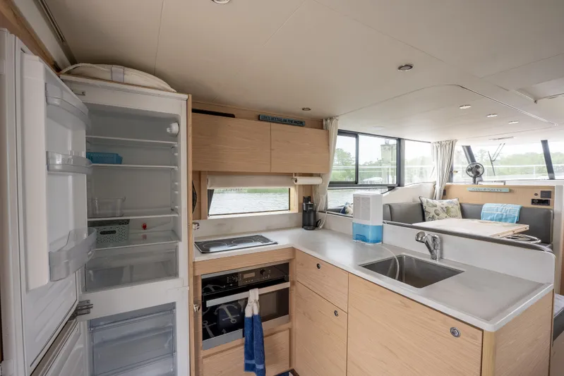 Sweetest Southern Comfort Yacht Photos Pics 2022 Beneteau ST48 Swift Trawler 48 interior kitchen with modern appliances and open layout.