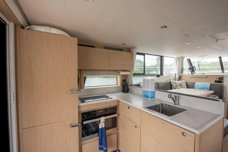 Sweetest Southern Comfort Yacht Photos Pics Interior of 2022 Beneteau ST48 Swift Trawler 48, featuring modern kitchen and spacious seating area.