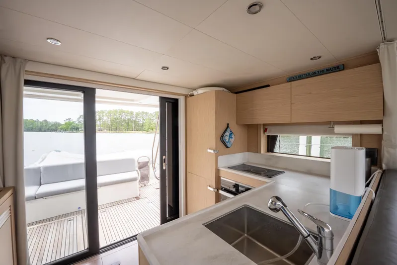 Sweetest Southern Comfort Yacht Photos Pics Modern kitchen interior of 2022 Beneteau ST48 Swift Trawler 48 with outdoor view.