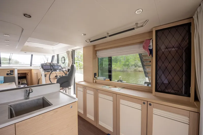 Sweetest Southern Comfort Yacht Photos Pics Interior of 2022 Beneteau ST48 Swift Trawler 48, featuring modern kitchen and helm station.