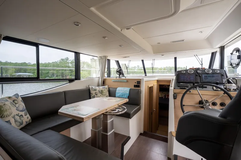 Sweetest Southern Comfort Yacht Photos Pics Interior of 2022 Beneteau ST48 Swift Trawler 48, featuring helm and seating area.