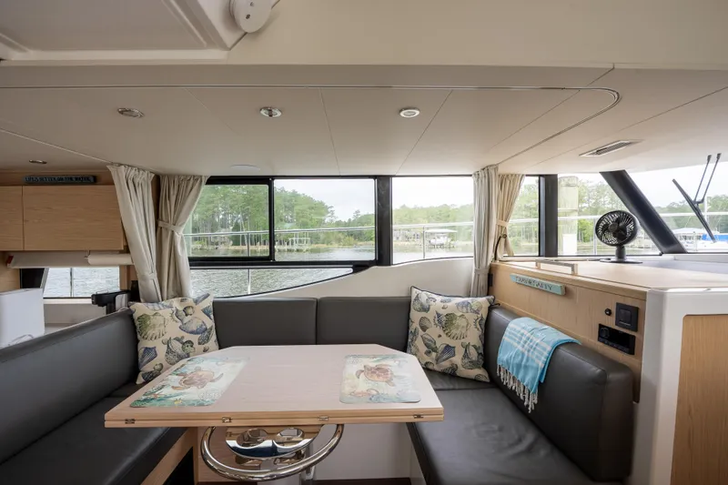 Sweetest Southern Comfort Yacht Photos Pics Interior of 2022 Beneteau ST48 Swift Trawler 48 with cozy seating and large windows.
