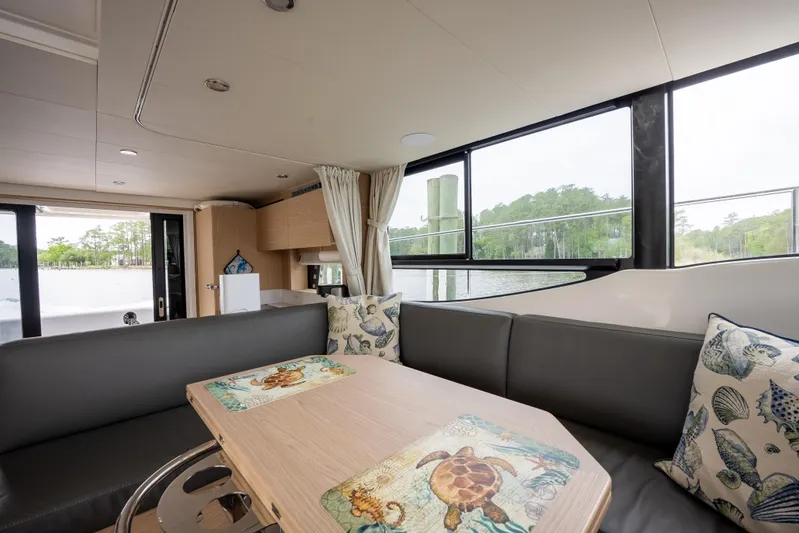 Sweetest Southern Comfort Yacht Photos Pics Interior of 2022 Beneteau ST48 Swift Trawler 48 with cozy seating and decorative pillows.