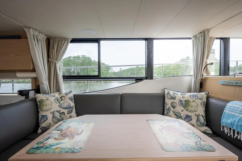 Sweetest Southern Comfort Yacht Photos Pics Interior of 2022 Beneteau ST48 Swift Trawler 48 with cozy seating and decorative pillows.