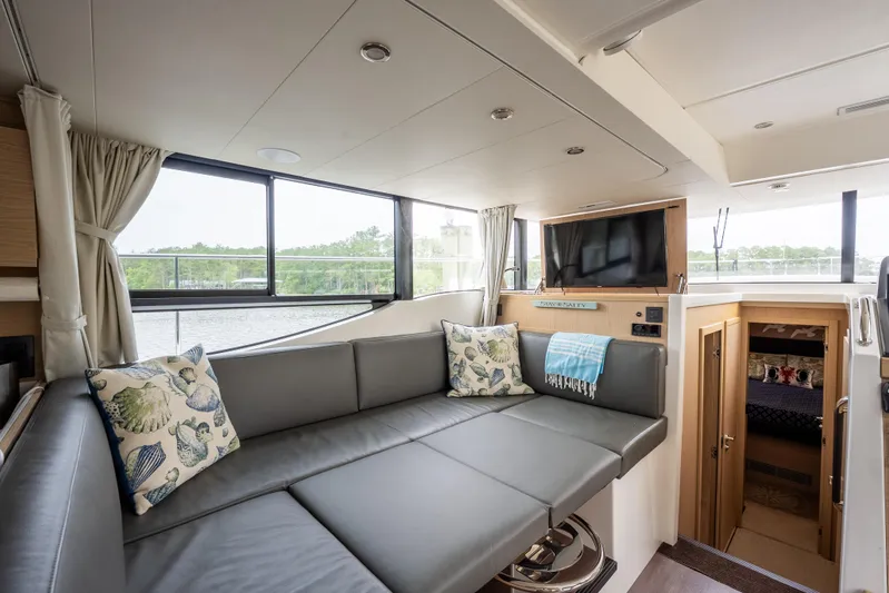 Sweetest Southern Comfort Yacht Photos Pics Interior of 2022 Beneteau ST48 Swift Trawler 48 with modern seating and large windows.