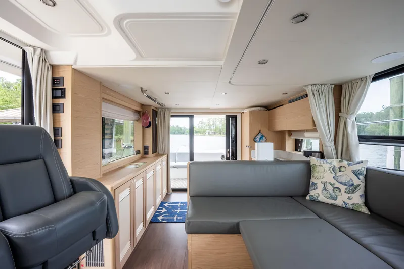 Sweetest Southern Comfort Yacht Photos Pics Interior of 2022 Beneteau ST48 Swift Trawler 48, featuring modern seating and large windows.