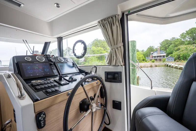 Sweetest Southern Comfort Yacht Photos Pics Interior helm of 2022 Beneteau ST48 Swift Trawler 48, featuring modern navigation equipment.