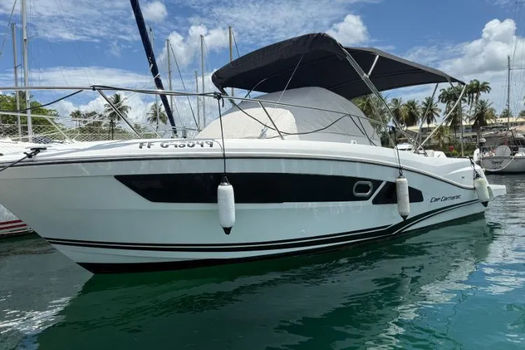 P'tit Bateau Yacht Photos Pics 2022 Jeanneau Cap Camarat 9.0 WA boat docked in marina, under clear blue sky.