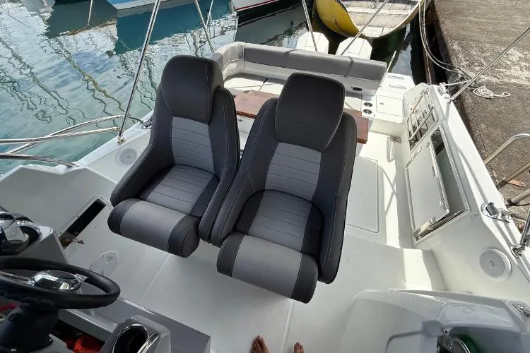P'tit Bateau Yacht Photos Pics 2022 Jeanneau Cap Camarat 9.0 WA boat interior with dual seats and steering wheel.