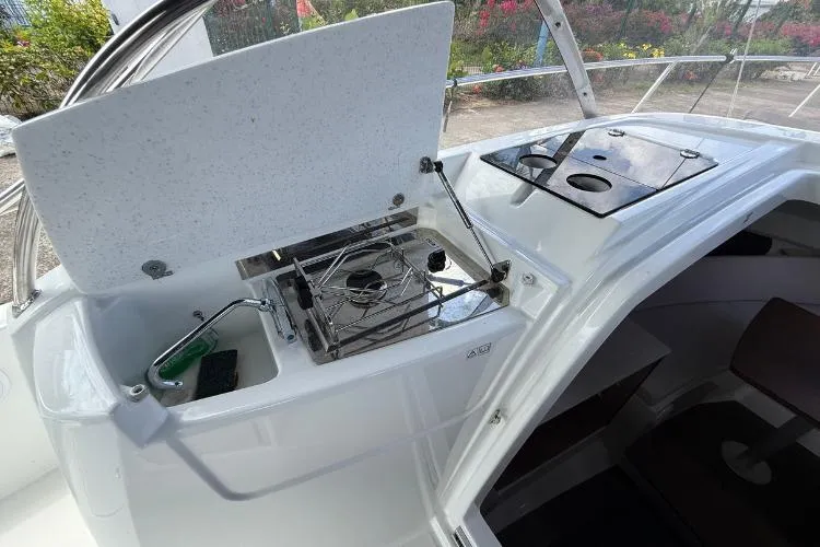 P'tit Bateau Yacht Photos Pics 2022 Jeanneau Cap Camarat 9.0 WA boat interior with compact kitchen setup.