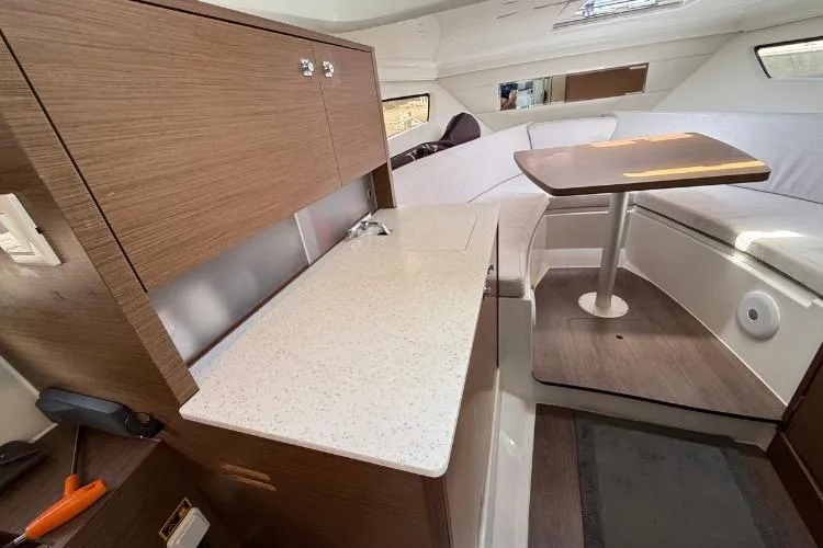P'tit Bateau Yacht Photos Pics Interior of 2022 Jeanneau Cap Camarat 9.0 WA with kitchenette and seating area.