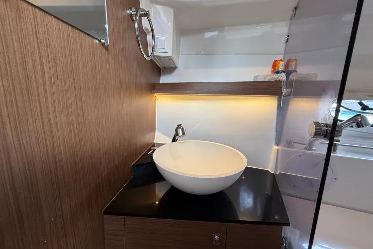 P'tit Bateau Yacht Photos Pics Modern bathroom interior of 2022 Jeanneau Cap Camarat 9.0 wa boat, featuring sleek sink design.