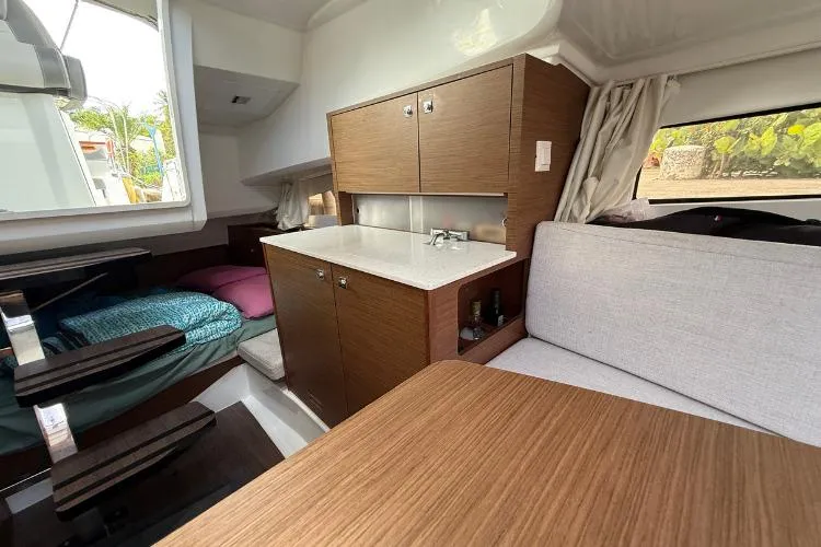 P'tit Bateau Yacht Photos Pics Interior of 2022 Jeanneau Cap Camarat 9.0 WA with modern wood finish and cozy seating.