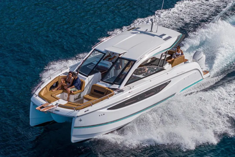  Yacht Photos Pics Manufacturer Provided Image: 2026 Jeanneau TH38 motor yacht cruising on blue ocean waters.