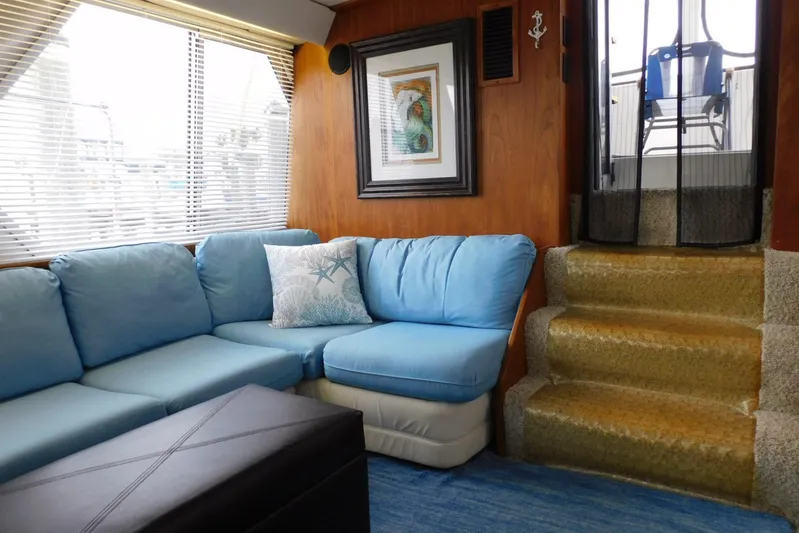La Vida Yacht Photos Pics Interior of 1993 Carver 445 Aft Cabin Motor Yacht with blue seating and nautical decor.
