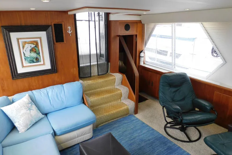 La Vida Yacht Photos Pics Interior of 1993 Carver 445 Aft Cabin Motor Yacht with blue seating and wooden accents.