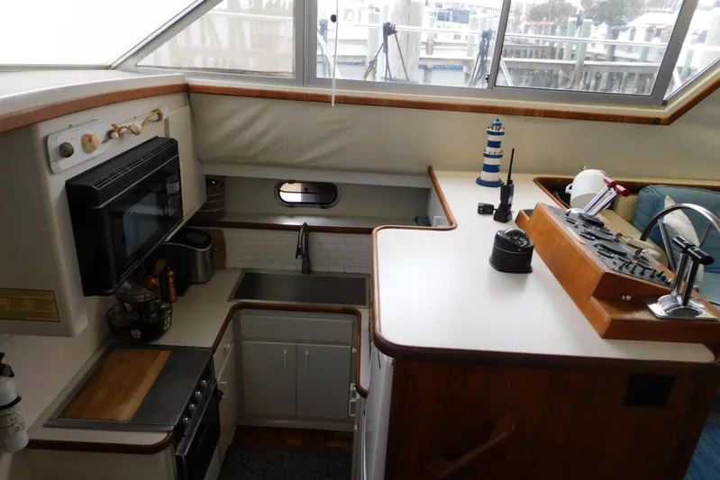 La Vida Yacht Photos Pics Interior of 1993 Carver 445 Aft Cabin Motor Yacht with kitchen and control panel.
