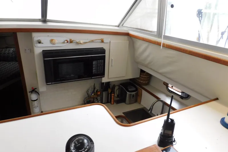 La Vida Yacht Photos Pics Interior of 1993 Carver 445 Aft Cabin Motor Yacht kitchen with microwave and appliances.