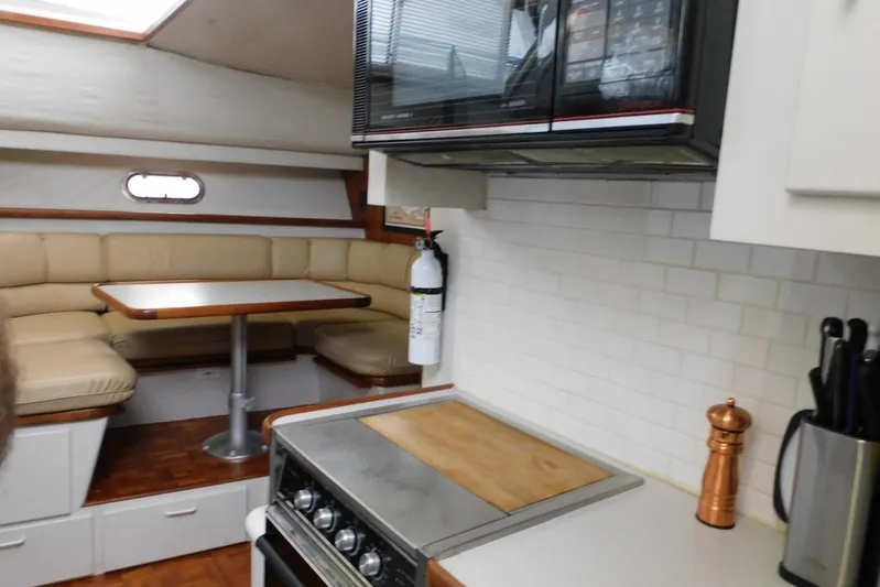 La Vida Yacht Photos Pics 1993 Carver 445 Aft Cabin Motor Yacht interior with kitchen and dining area.