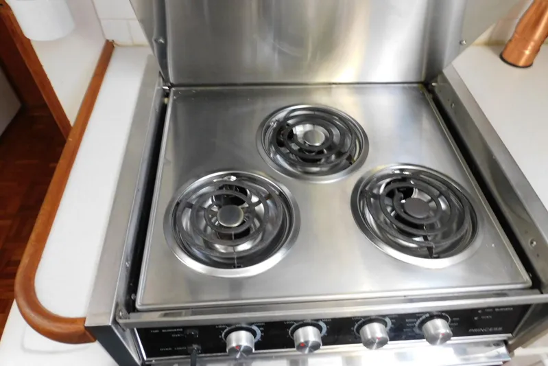 La Vida Yacht Photos Pics Stainless steel stove with three burners on a 1993 Carver 445 Aft Cabin Motor Yacht.