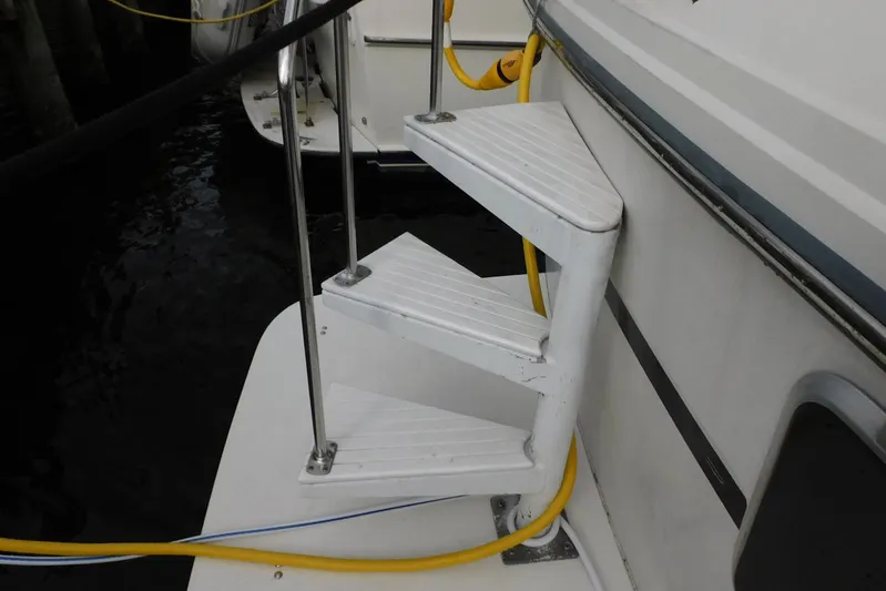 La Vida Yacht Photos Pics Staircase on 1993 Carver 445 Aft Cabin Motor Yacht with yellow cable.