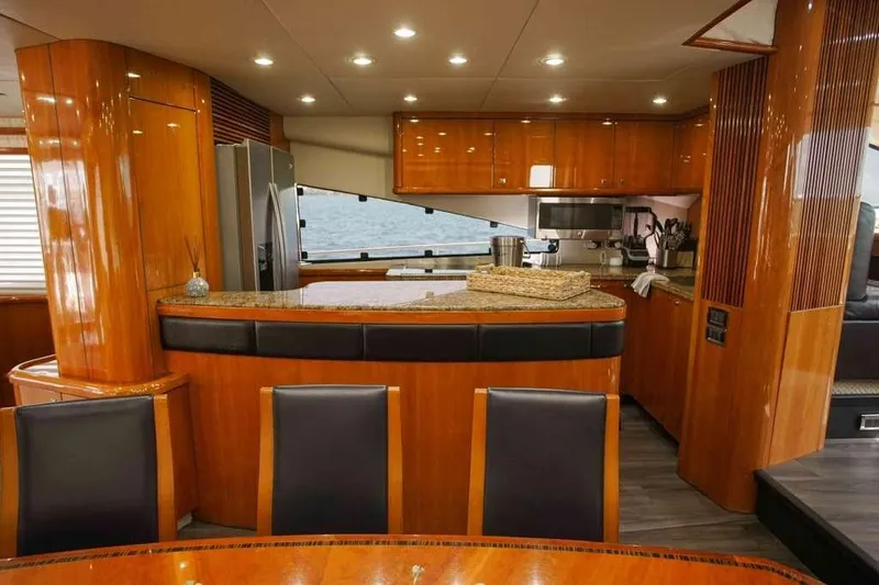 Fins Up Yacht Photos Pics Luxurious kitchen interior of 2006 Sunseeker Manhattan Motor 82 yacht with wood finish.