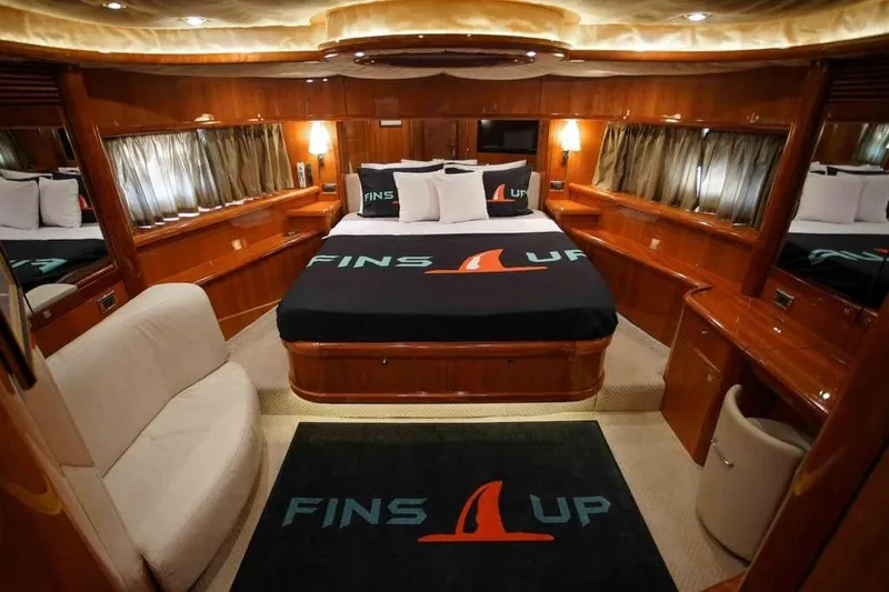 Fins Up Yacht Photos Pics Luxurious cabin interior of 2006 Sunseeker Manhattan Motor 82 yacht, featuring elegant wood finishes.