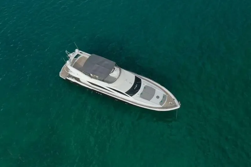 Fins Up Yacht Photos Pics Aerial view of 2006 Sunseeker Manhattan Motor 82 yacht on clear blue water.