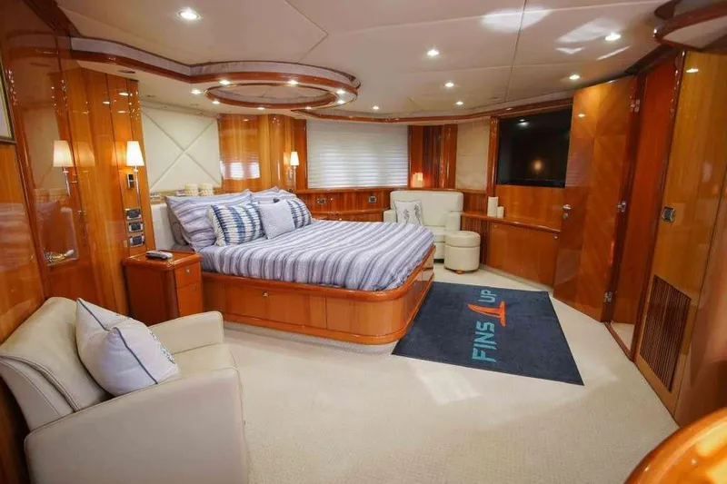 Fins Up Yacht Photos Pics Luxurious bedroom interior of 2006 Sunseeker Manhattan Motor 82 yacht, featuring elegant wood finishes.