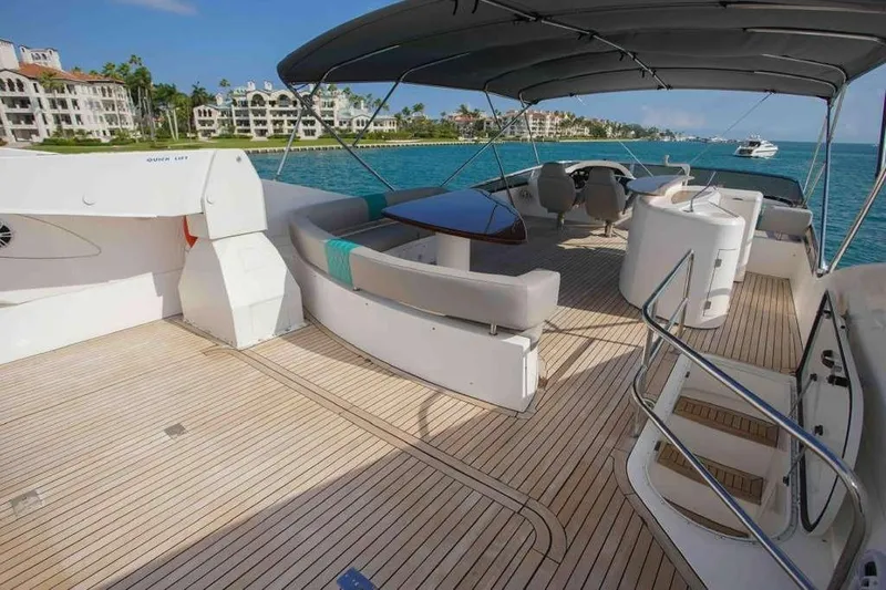 Fins Up Yacht Photos Pics Luxurious 2006 Sunseeker Manhattan Motor 82 yacht deck with elegant seating and ocean view.