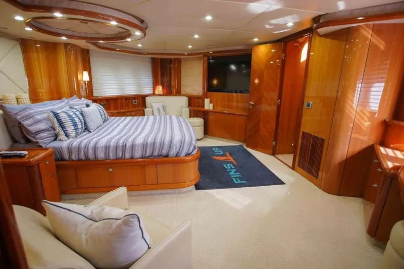 Fins Up Yacht Photos Pics Luxurious bedroom interior of 2006 Sunseeker Manhattan Motor 82 yacht with elegant wood finishes.