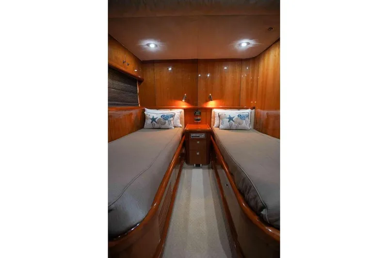Fins Up Yacht Photos Pics Luxurious twin cabin in 2006 Sunseeker Manhattan Motor 82 yacht, featuring elegant wood paneling.