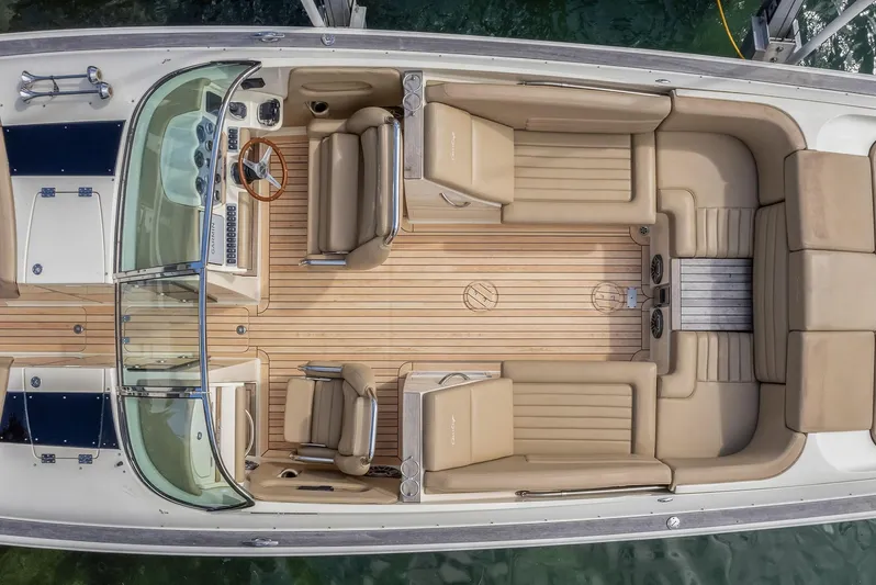 Chris-craft Launch 32 Yacht Photos Pics 2013 Chris-Craft Launch 32 boat interior with beige seating and wooden deck, viewed from above.