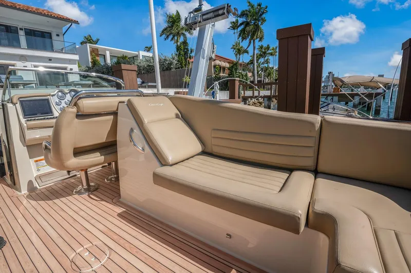 Chris-craft Launch 32 Yacht Photos Pics 2013 Chris-Craft Launch 32 boat interior with beige leather seating and wooden deck.