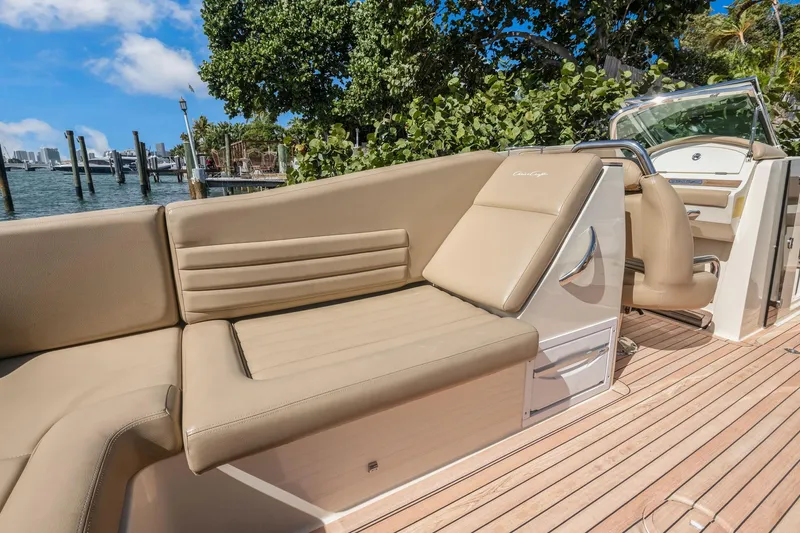 Chris-craft Launch 32 Yacht Photos Pics 2013 Chris-Craft Launch 32 boat with beige seating, dockside view, and lush greenery.