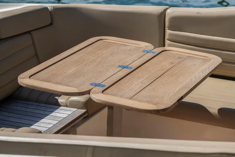 Chris-craft Launch 32 Yacht Photos Pics 2013 Chris-Craft Launch 32 boat interior with wooden table and beige seating.