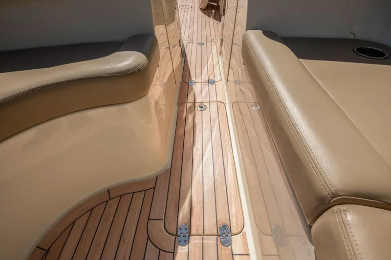 Chris-craft Launch 32 Yacht Photos Pics 2013 Chris-Craft Launch 32 interior with teak flooring and beige leather seating.