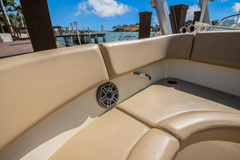 Chris-craft Launch 32 Yacht Photos Pics 2013 Chris-Craft Launch 32 boat interior with beige seating and speaker, dockside view.