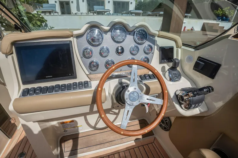 Chris-craft Launch 32 Yacht Photos Pics 2013 Chris-Craft Launch 32 dashboard with wooden steering wheel and modern controls.