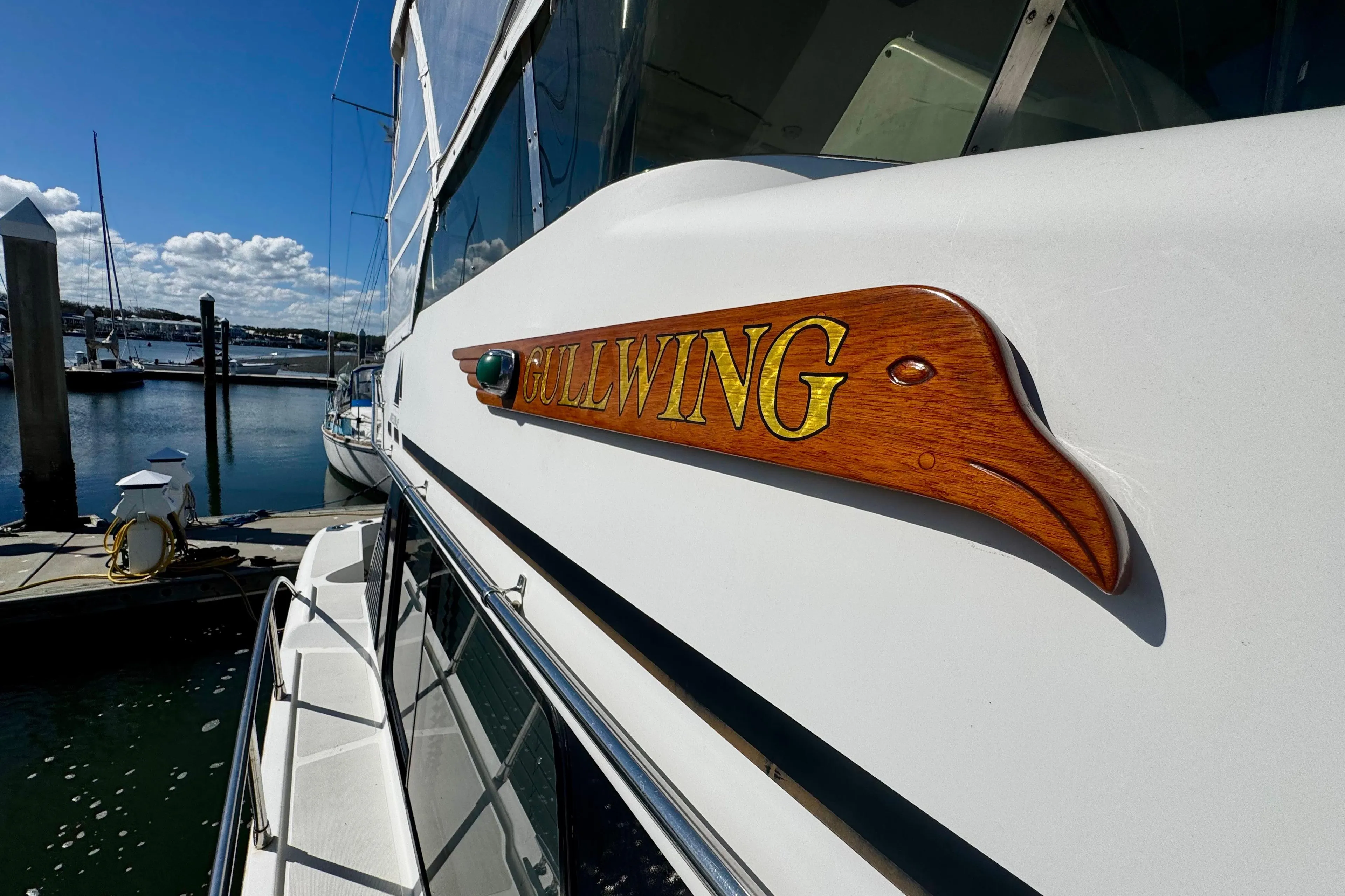 1998 Mikelson 43 Sportfisher docked, featuring "Gullwing" wooden nameplate.